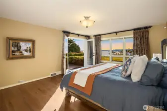 Incredible views continue to the primary suite boasting new wood floors in 2024. The French doors lead out to the private patio and hot tub.