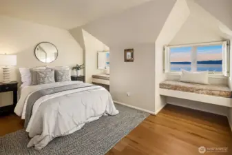 Upstairs bedroom offers 2 window seats to take in the view and new wood floors in 2024.