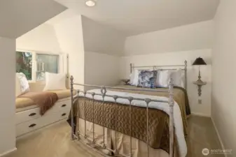 Third upstairs bedroom with window seat and built-ins for additional storage.