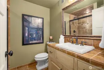 Lower level bath boasts custom tile.