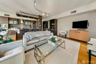 Spacious open living layout with a gorgeous kitchen on display, eating bar, dining table, built-in storage and office space too.