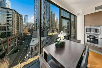 The SE corner curved window walls create functional dining space with a view.