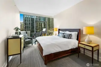 Primary bedroom fit for a king size bed with room to move (or exercise) too.