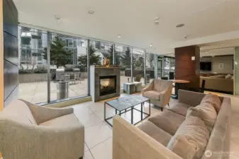 Resident lounge with indoor/outdoor fireplace for a cozy retreat.