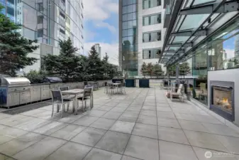 Resident sundeck with multiple barbecue grills, dining tables and chairs for outdoor enjoyment.