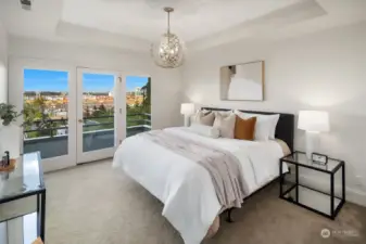 Main-level primary bedroom features high ceilings, designer lighting and expansive balcony with amazing views!