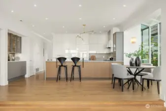 Expansive open concept view of kitchen and dining room from the living room.