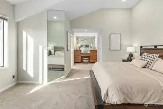 A generously sized primary bedroom featuring a built-in vanity, expansive walk-in closet, and a beautifully updated bathroom for a luxurious retreat.