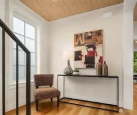 Upstairs at the 2nd level landing, one is greeted by solid wood floors, generous, light filled spaces, extensive millwork trim and warm paneled ceilings.