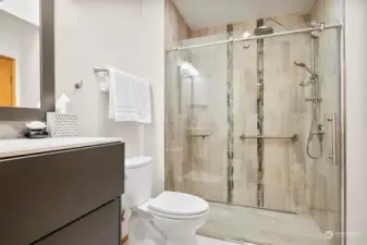 Beautifully updated secondary bathroom with zero-entry shower and HEATED TILE FLOORS!