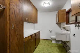 Seperate laundry room with toilet and sink