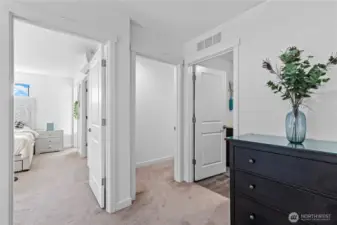 This level boasts two primary suites with private baths and a convenient laundry room.