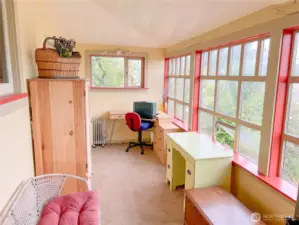 Delightful glassed space off porch...full of view.