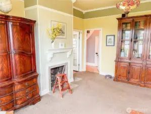 The living room here, and parlor connect with a doorway just right of the fireplace.