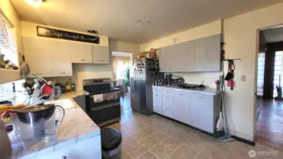Facing kitchen from utility room/back door entrance