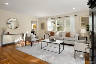 The covered porch opens up to the formal living room that is bathed in natural light.