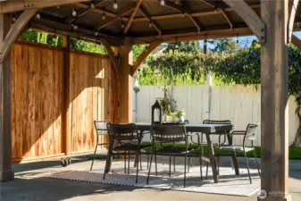 Just out of the walk-out basement is the mostly level backyard and this custom gazebo with privacy doors.