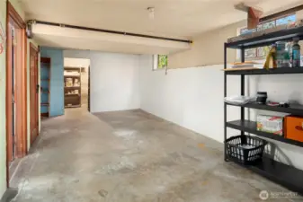 Looking through the attached garage with interior access. At the end of the garage is another room perfect for more storage or shop area.