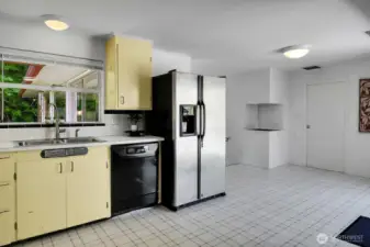 The kitchen is open to an informal dining space.