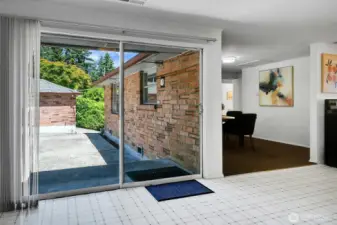 Over-sized slider off the kitchen leads to the expansive patio, perfect for entertaining! Photo shows the detached 1-car garage.
