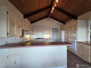 kitchen with lots of cupboard space, and custom ceiling beams
