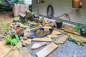 Waterfall/pond w/stone patio area.