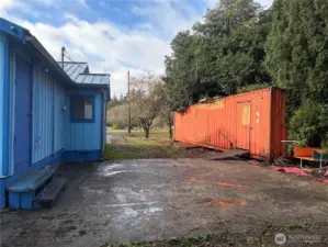 Side of home of home and storage container.