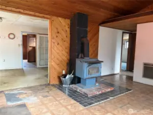 Electric wall heat with wood stove for back up. Kitchen /dining room to left. Bedrooms and full bath to the right.