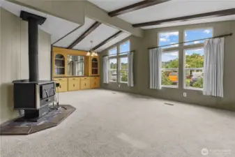 From the front door, enter into the great room with large windows letting in lots of light.  Wood stove is practical for keeping warm and cozy all winter.