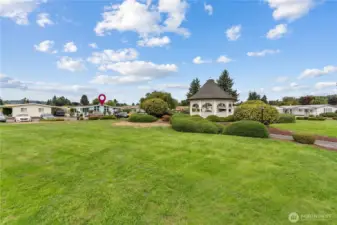 Park area has gazebo and grassy area.