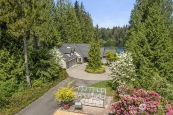 Home is situated on almost 2 lush acres with long circular driveway.