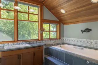 The primary bathroom has a large, separate tub.