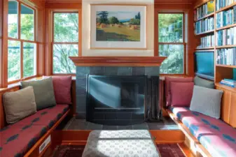 The Inglenook, a cozy nook with built-in benches, fireplace and bookcases.