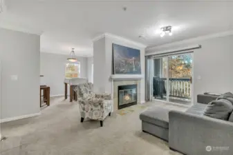 Living room with ton of natural light and tree lined views.