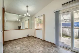 Dining area leading to back patio, plenty of light,