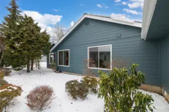 View of back of unit.  Patio area has walk way from door around corner to patio below the two windows.