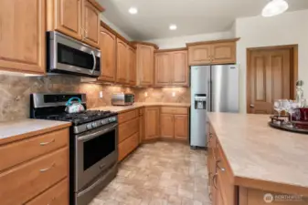 Stainless appliances all stay including gas range. Full tile back splash. Crown molding topped cabinetry. Soft-close drawers.