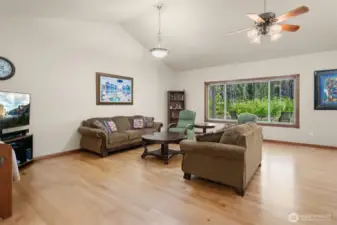 Soaring vaulted ceilings grace the Great room, combining Living, Dining, and Kitchen.