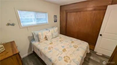 Comfortable and cleverly arranged, this second bedroom offers serene style and standout storage with a wall-to-wall closet.  A flexible space that combines coastal charm with practical design for easy, breezy functionality.