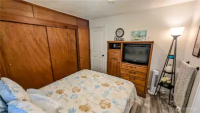 Comfortable and cleverly arranged, this second bedroom offers serene style and standout storage with a wall-to-wall closet.  A flexible space that combines coastal charm with practical design for easy, breezy functionality.