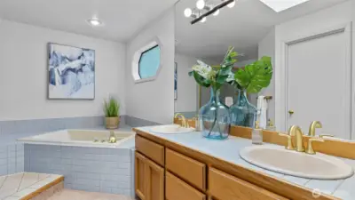 Spacious, elegant and relaxing primary bathroom with a deep soaking tub, doubled sink counter, and long shower stall.