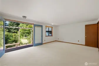 Generous Primary suite with french doors leading to back yard gardens.