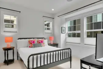 The guest room enjoys the same wool carpet and lots of windows.