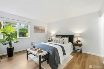 The primary suite has an en-suite bathroom and custom Shoji closet doors.