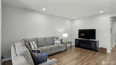 Spacious living room with room for a large sectional couch adjacent to the kitchen and dining area