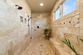 Walk in shower with travertine tile.