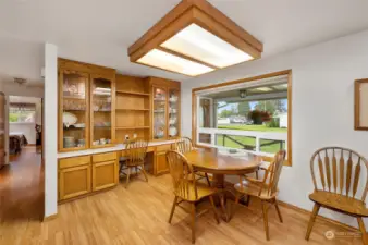From this angle you can see more of the kitchen, which features a spacious china hutch, storage cabinets, and a practical desk.