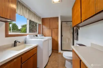 Adjacent to the family room, there is a 3/4 bathroom/laundry with plenty of counter space.