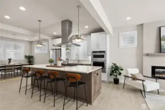 The kitchen is at the heart of the home featuring a large island with seating, pendant lights, a 5-burner gas cooktop with extraction hood and thick slab quartz countertops.  The family room and dining room are flanked on both sides of the kitchen.