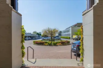 Elegant Courtyard Entrance Featuring a Fountain and Convenient Exterior Parking